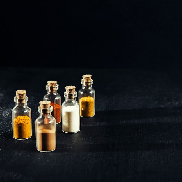 Six small sample bottles laid out beside a patch-test card