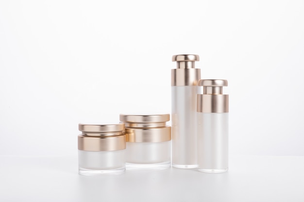 Two rows of skincare bottles set out side by side for comparison
